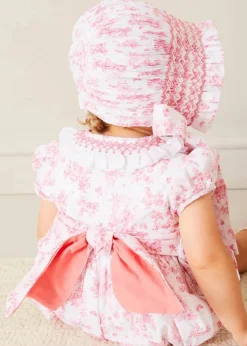 Lookbooks | Pepa London Audrey Hand Smocked Double Breasted Short Sleeve Romper in Pink (6mths-2yrs) | Audrey Toile Hand Smocked Bonnet in Pink (S-M) | Openwork Cotton Cardigan in Pink (6mths-10yrs) | Mary Jane Pram Shoes in Pink (17-20EU) | Openwork short socks White (0mths-8yrs)