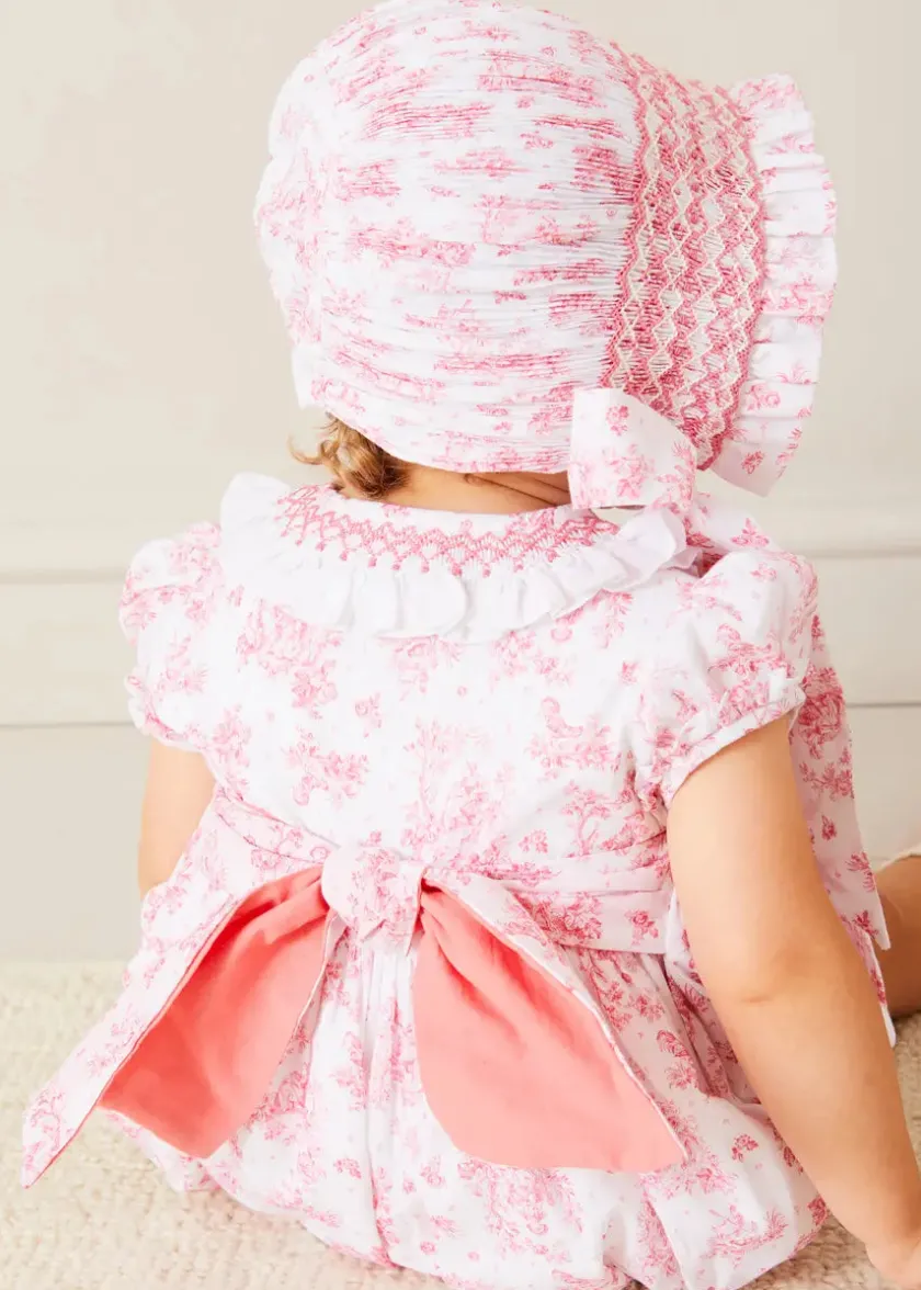 Lookbooks | Pepa London Audrey Hand Smocked Double Breasted Short Sleeve Romper in Pink (6mths-2yrs) | Audrey Toile Hand Smocked Bonnet in Pink (S-M) | Openwork Cotton Cardigan in Pink (6mths-10yrs) | Mary Jane Pram Shoes in Pink (17-20EU) | Openwork short socks White (0mths-8yrs)