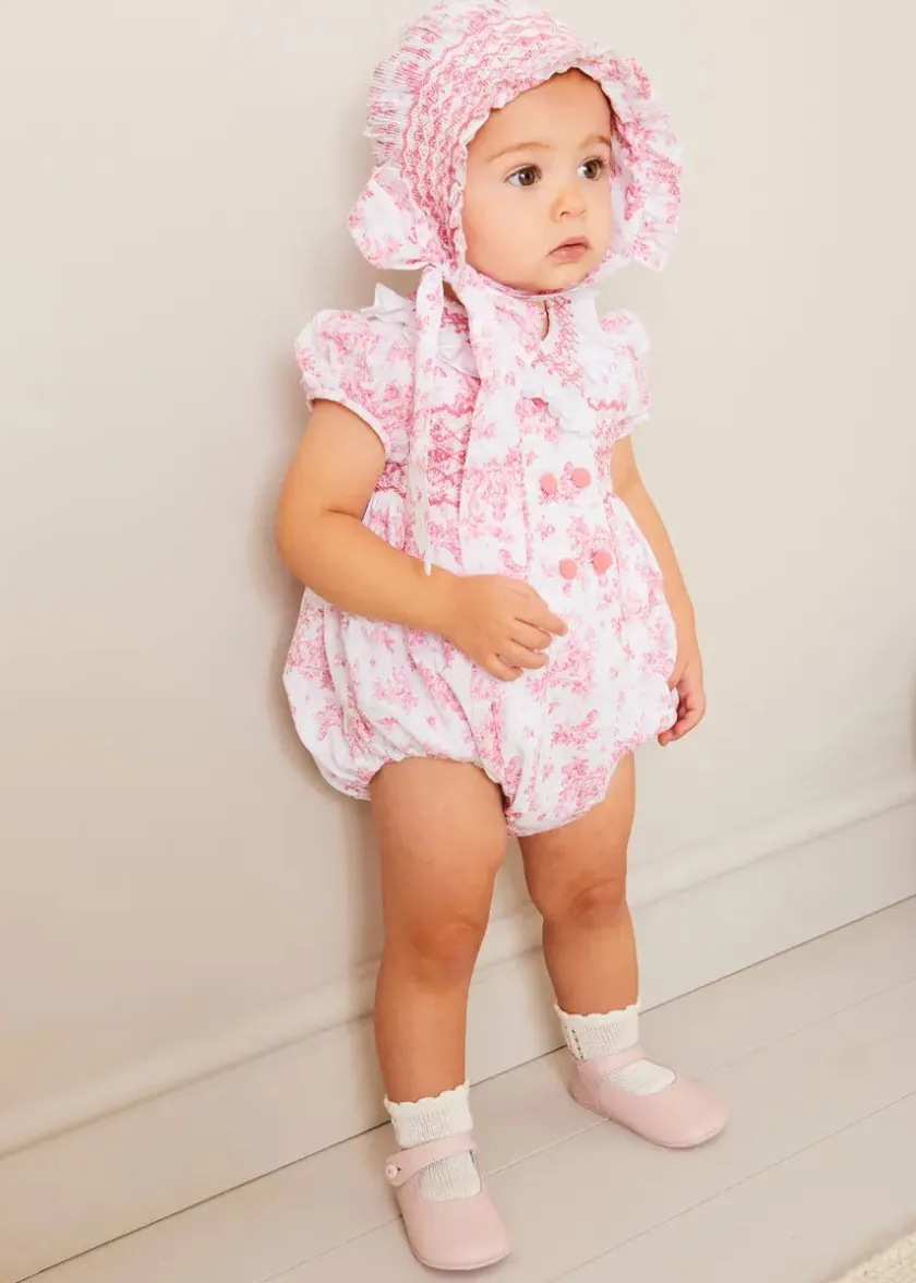 Lookbooks | Pepa London Audrey Hand Smocked Double Breasted Short Sleeve Romper in Pink (6mths-2yrs) | Audrey Toile Hand Smocked Bonnet in Pink (S-M) | Openwork Cotton Cardigan in Pink (6mths-10yrs) | Mary Jane Pram Shoes in Pink (17-20EU) | Openwork short socks White (0mths-8yrs)