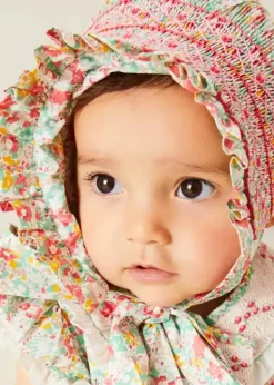 Lookbooks | Pepa London Clementine Floral Hand Smocked Double Breasted Short Sleeve Romper in Coral (6mths-3yrs) | Clementine Floral Hand Smocked Bonnet in Coral (S-M) | Openwork Cotton Cardigan in Cream (6mths-10yrs) | Leather Mary Jane Pram Shoes in Ivory (17-20EU) | Openwork short socks White (0mths-8yrs)