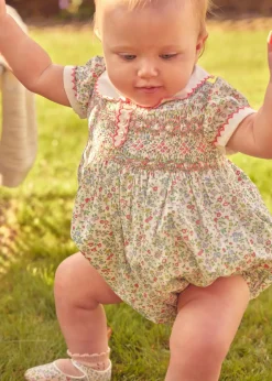 Lookbooks | Pepa London Cordelia Floral Hand-Smocked Short Sleeve Romper in Pink Made with Liberty Fabric (3m-2yrs) | Openwork Cotton Knitted Bonnet in Pink (S-L) | Openwork Cotton Cardigan in Pink (6mths-10yrs) | Cordelia Liberty Floral Mary Jane Pram Shoes in Pink (17-20EU) | Flower Fairies of the Spring Book in White | Cordelia Floral Small Bow Clip in Pink Made with Liberty Fabric | Openwork short socks White (0mths-8yrs)