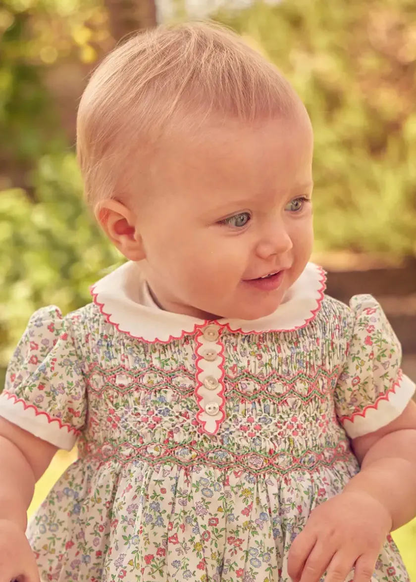 Lookbooks | Pepa London Cordelia Floral Hand-Smocked Short Sleeve Romper in Pink Made with Liberty Fabric (3m-2yrs) | Openwork Cotton Knitted Bonnet in Pink (S-L) | Openwork Cotton Cardigan in Pink (6mths-10yrs) | Cordelia Liberty Floral Mary Jane Pram Shoes in Pink (17-20EU) | Flower Fairies of the Spring Book in White | Cordelia Floral Small Bow Clip in Pink Made with Liberty Fabric | Openwork short socks White (0mths-8yrs)