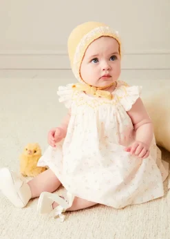 Lookbooks | Pepa London Esme Floral Hand Smocked Sleeveless Dress With Bloomers in White (1-12mths) | Openwork Detail Cotton Baby Cardigan in Tangerine (1-12mths) | Lace Detail Knitted Bonnet in Tangerine (1-12mths) | Celebration Ribbon Detail Mary Jane Pram Shoes in Beige (17-20EU) | Esme Floral Dummy Clip in White | Openwork short socks White (0mths-8yrs) | Chick Toy in Yellow