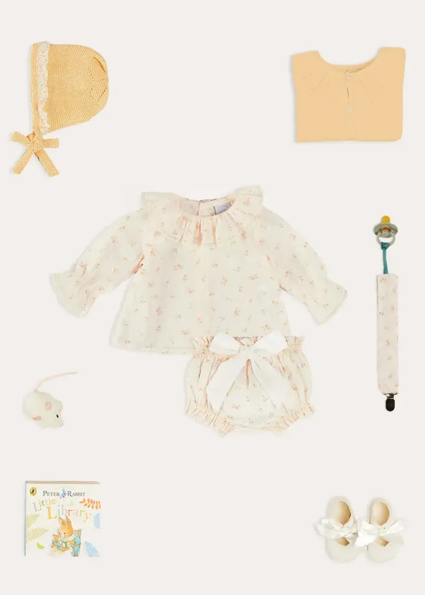 Lookbooks | Pepa London Esme Floral Ruffle Collar Long Sleeve Blouse in White (1-12mths) | Esme Floral Bow Detail Bloomers in White (1-12mths) | Openwork Detail Cotton Baby Cardigan in Tangerine (1-12mths) | Lace Detail Knitted Bonnet in Tangerine (1-12mths) | Celebration Ribbon Detail Mary Jane Pram Shoes in Beige (17-20EU) | Esme Floral Dummy Clip in White | Little Library Book in White