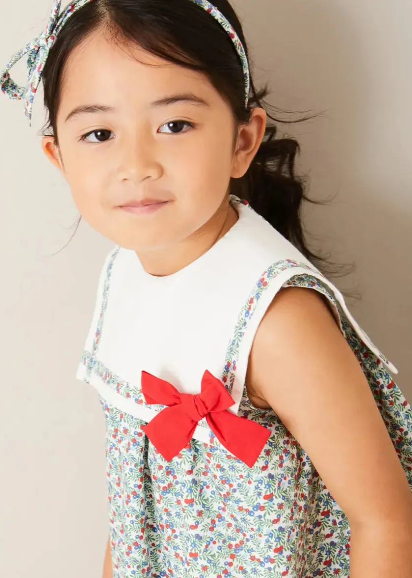 Lookbooks | Pepa London Evelyn Floral Sleeveless Bow Detail Trapeze Dress in Red (12mths-8yrs) | Openwork Cotton Cardigan in Cream (6mths-10yrs) | Evelyn Floral Thin Bow Hairband in Red | Openwork short socks White (0mths-8yrs)