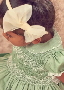 Lookbooks | Pepa London Hand Smocked Peter Pan Collar Short Sleeve Dress in Green (12mths-10yrs) | Openwork Cotton Cardigan in Cream (6mths-10yrs) | Girls Ivory Leather Mary Jane Shoes (20-34EU) | Traditional Big Bow Tulle Hairband in Ivory | Flower Fairies of the Spring Book in White | Openwork short socks White (0mths-8yrs)