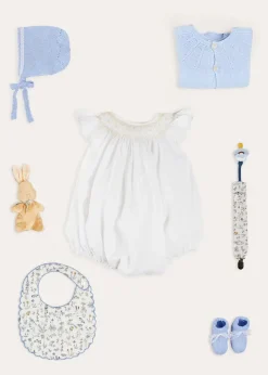 Lookbooks | Pepa London Hand Smocked Sleeveless Romper in White (3-18mths) | Openwork Detail Baby Cardigan in Blue (1-12mths) | Lace Detail Knitted Bonnet in Blue (1-6mths) | Ellis Rounded Bib with Embroidery in Blue Made with Liberty Fabric | Lace Detail Knitted Booties in Blue | Ellis Dummy Clip in Blue Made with Liberty Fabric | My First Bunny in a Box - Blue