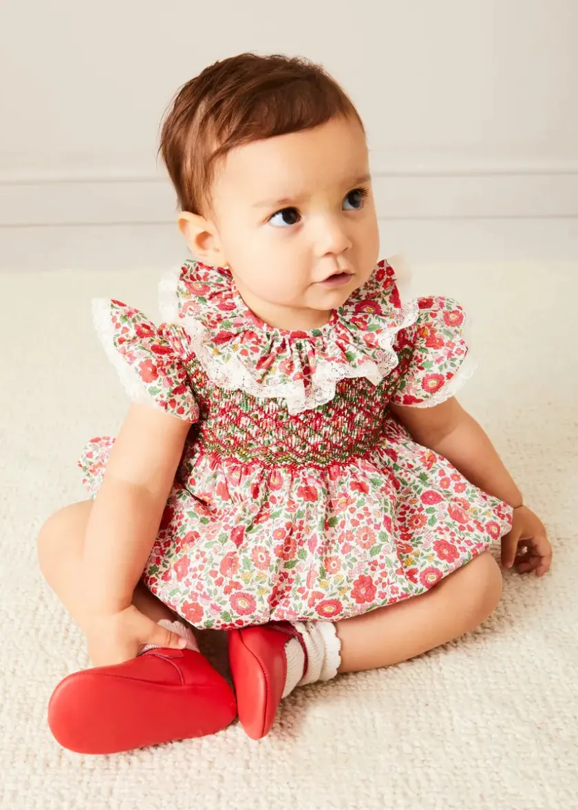 Lookbooks | Pepa London Margot Floral Romper in Red Made with Liberty Fabric (6m-2yrs) | Openwork Cotton Cardigan in Cream (6mths-10yrs) | Openwork Cotton Knitted Bonnet in Cream (S-L) | Leather Mary Jane Pram Shoes in Red (17-20EU) | Margot Dummy Clip in Red Made with Liberty Fabric | Openwork short socks White (0mths-8yrs) | BIBS Dummy in Pink