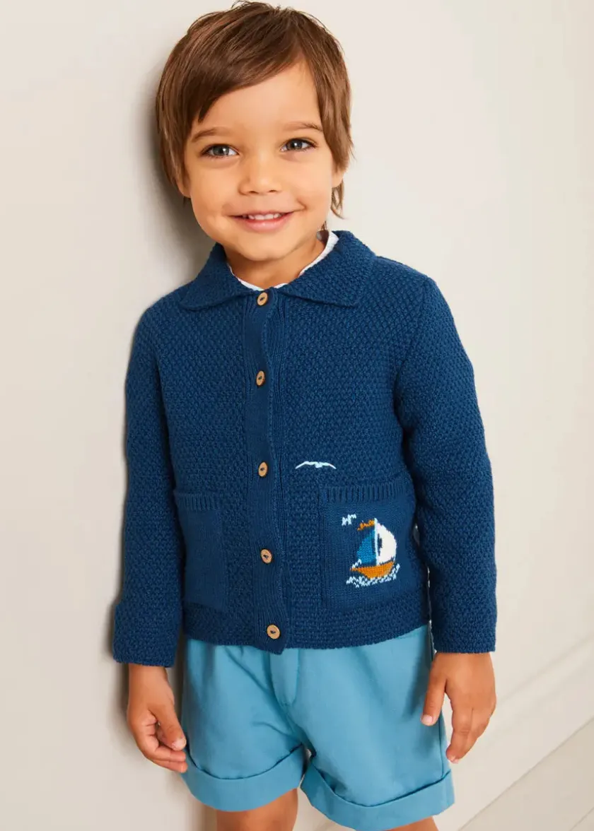 Lookbooks | Pepa London Nautical Boat Embroidery Polo Collar Cardigan in Blue (12mths-6yrs) | Chesham Striped Mao Collar Long Sleeve Shirt in Red (3-10yrs) | Plain Elasticated Shorts in Blue (12mths-4yrs) | T-Bar Baby Shoes in Blue (20-26EU) | Ribbed Short Socks in Beige (0mths-10yrs)